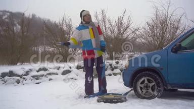 冬天，下着雪。 路上的人汽车出毛病了. 他正在等人把车拖走